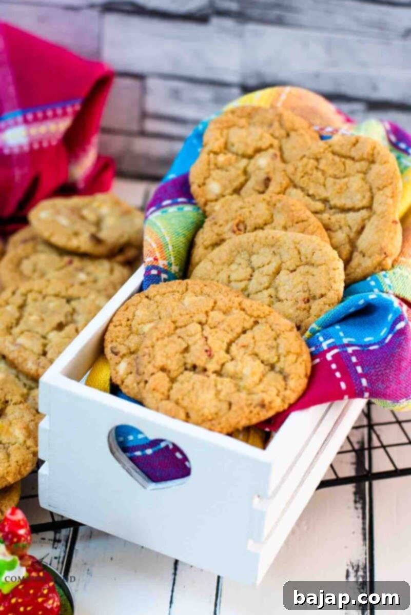 Soft, chewy and sweet strawberry cookies with white chocolate chips placed in a gorgeous white wooden crate.