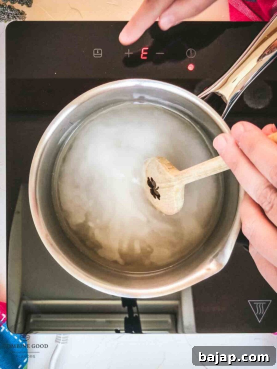 Stir the sugar water mixture, until the sugar is completely dissolved.