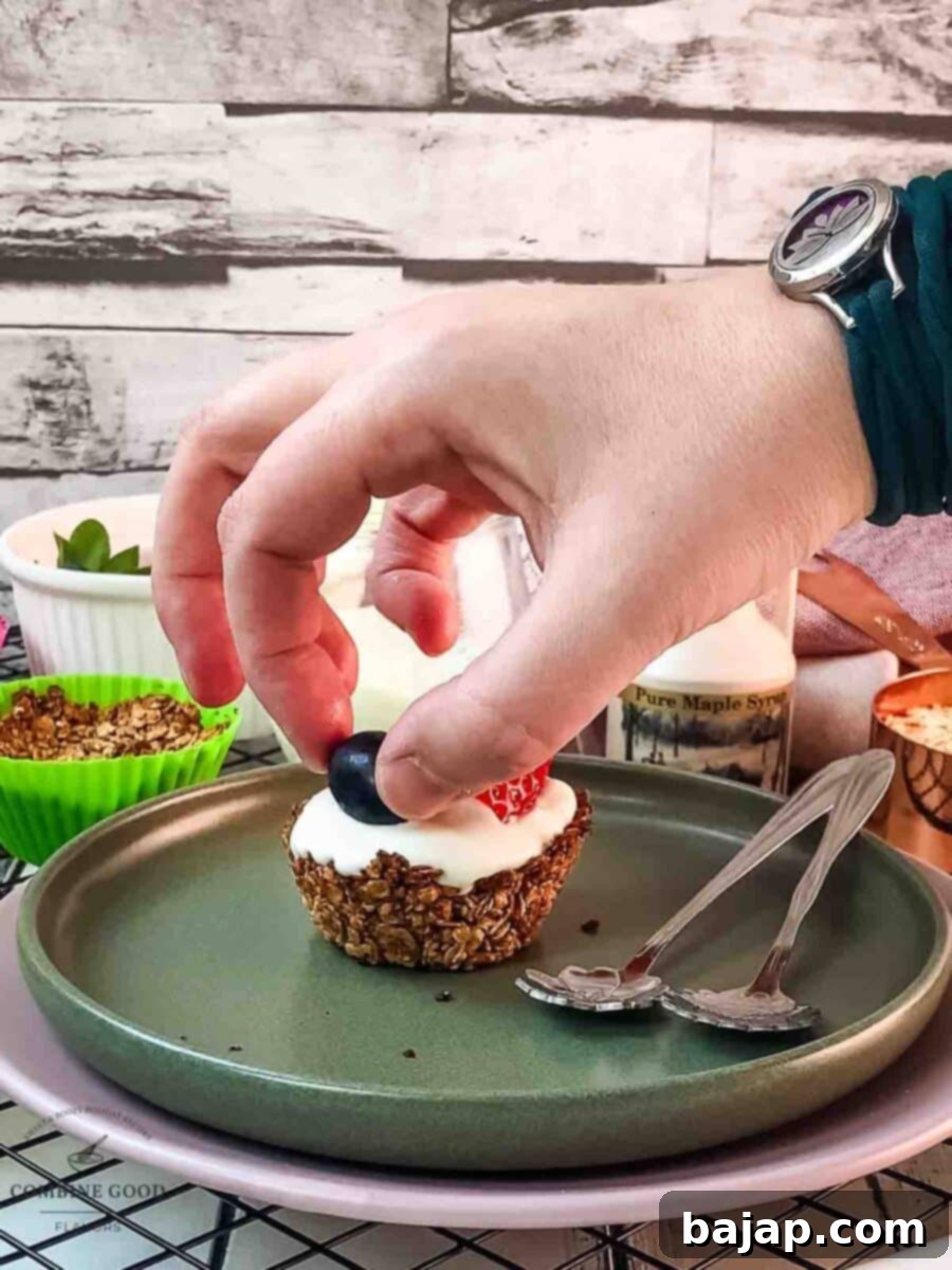 Place some sweet blue grapes on top of the yogurt filled granola cup.