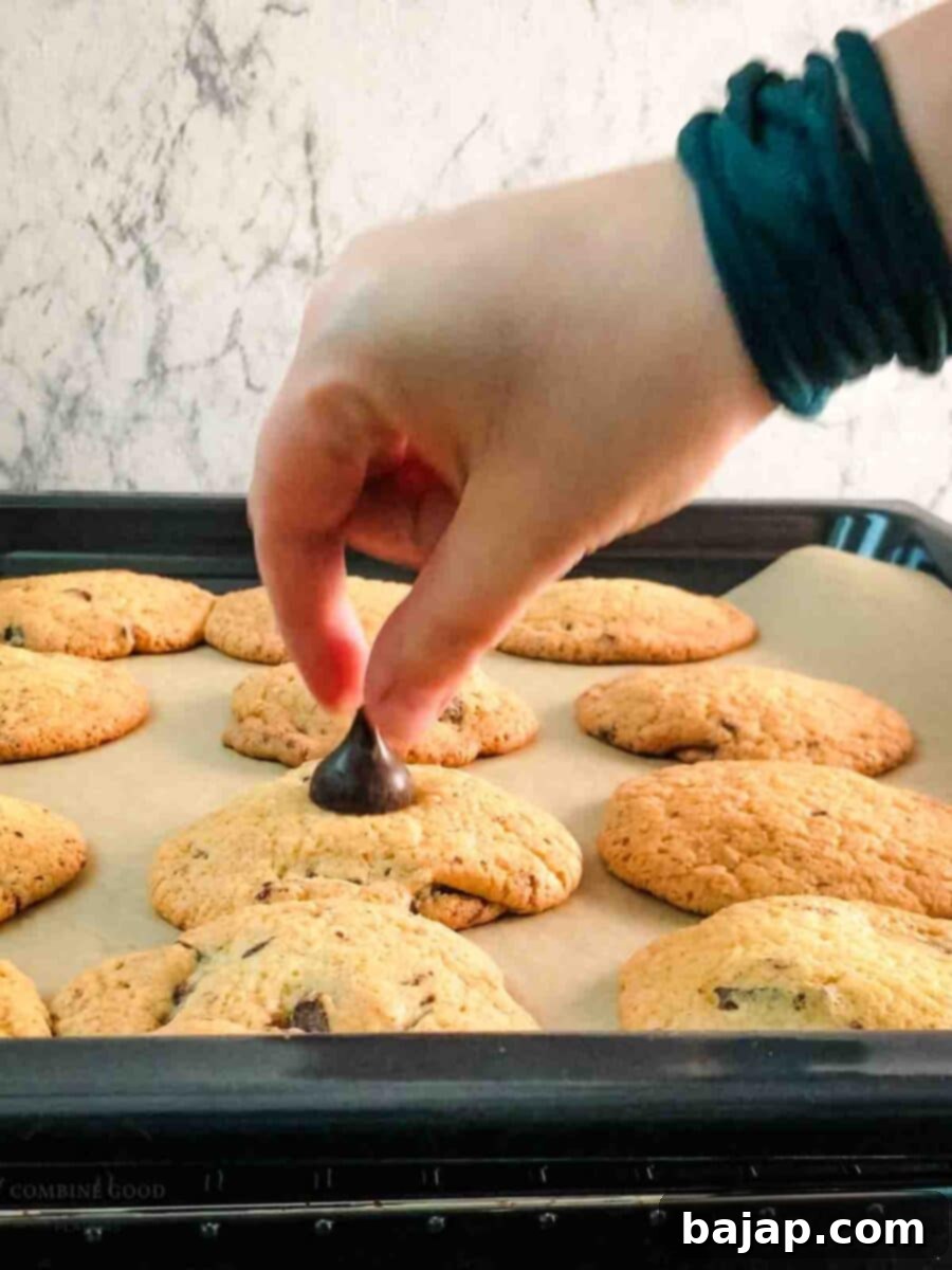 Place the Hershey kiss on top of the hot cookie.