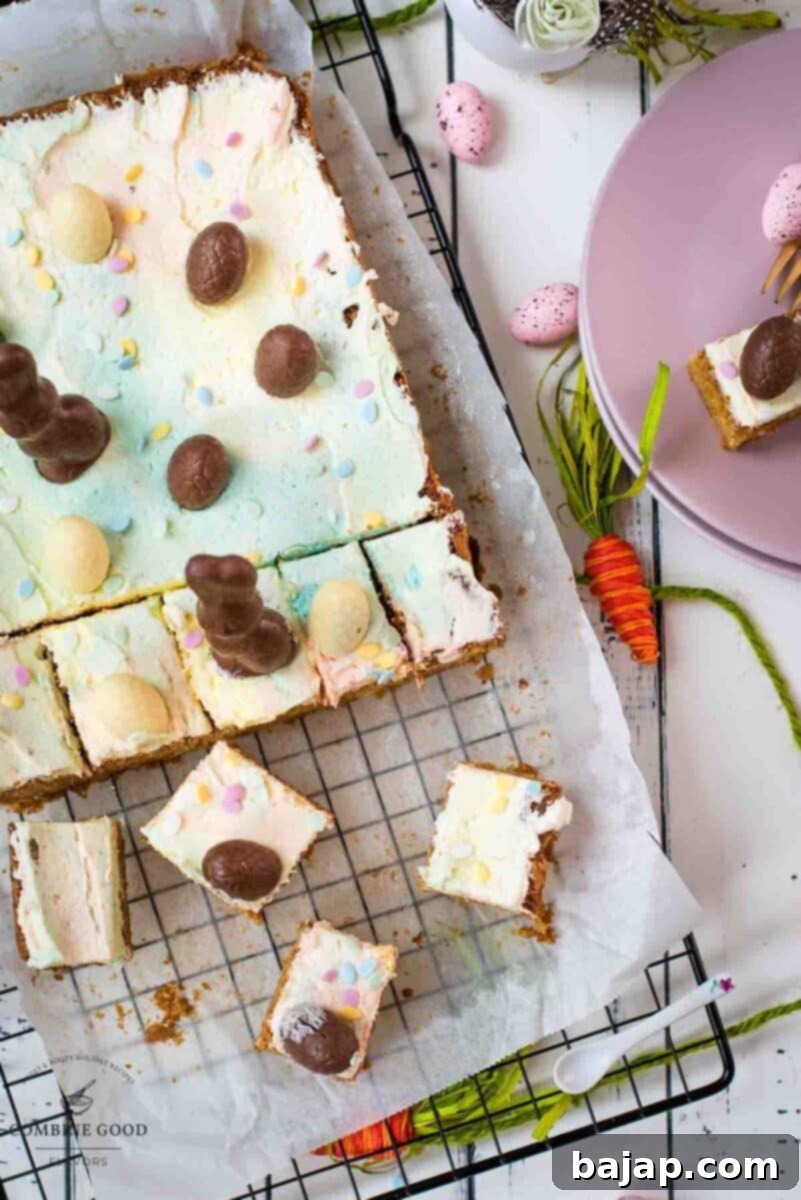 Overhead view of a tray of Funfetti Easter Sugar Cookie Bars with pastel marbled buttercream, before slicing.