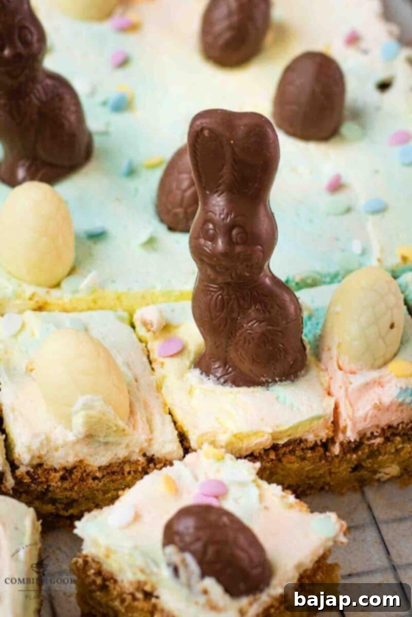 Individual Funfetti Easter Sugar Cookie Bars with marbled pastel frosting and Easter candy on a serving plate.