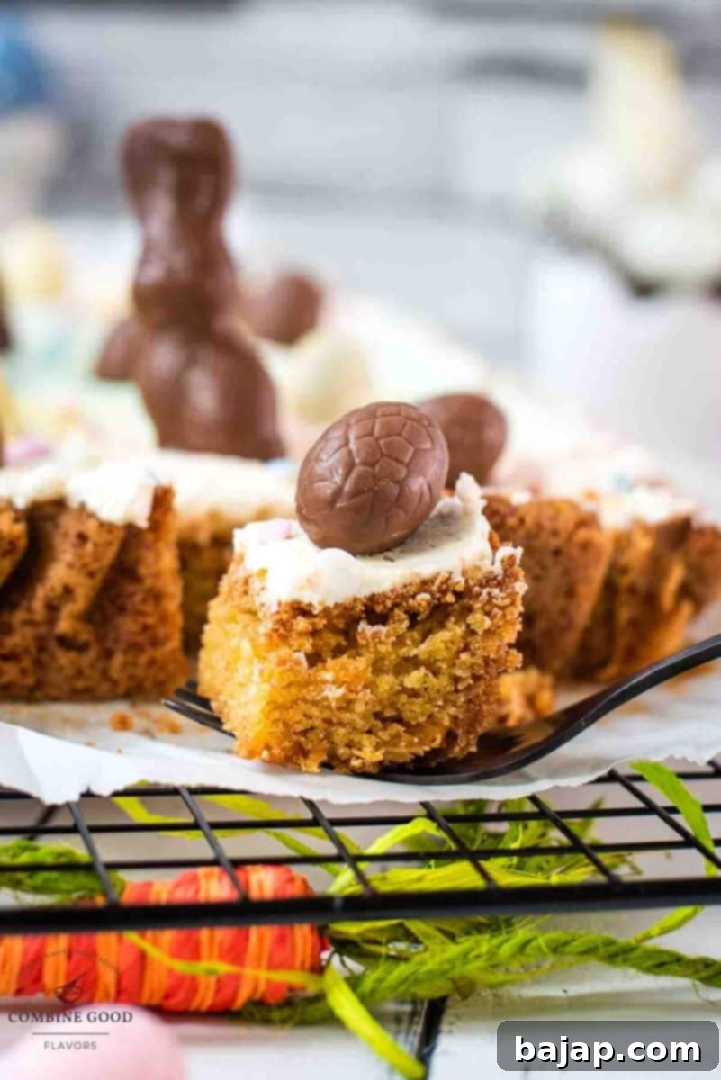 A close-up of a perfectly sliced Funfetti Easter Sugar Cookie Bar, displaying the soft cookie, marbled frosting, and festive toppings.