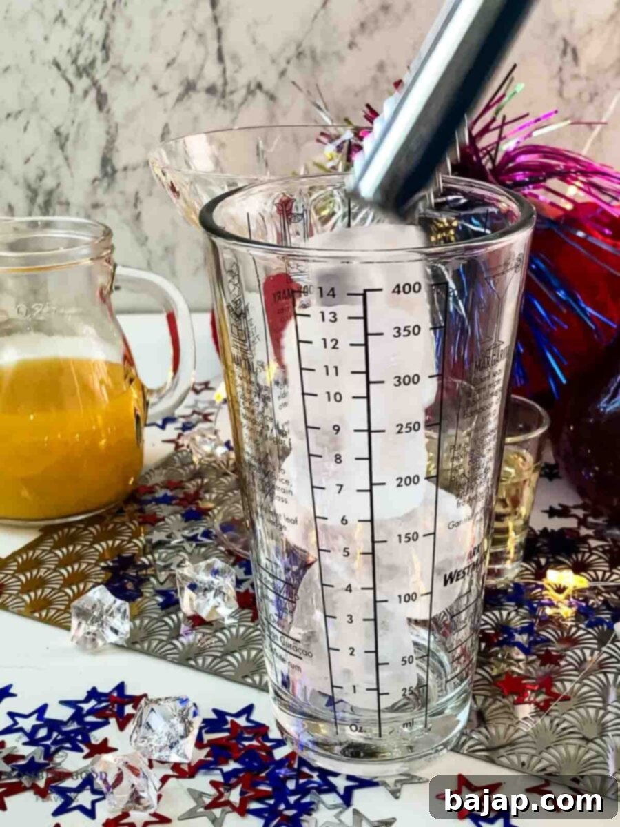 Add cubed ice to the cocktail shaker, initiating the chilling process for the margarita ingredients.
