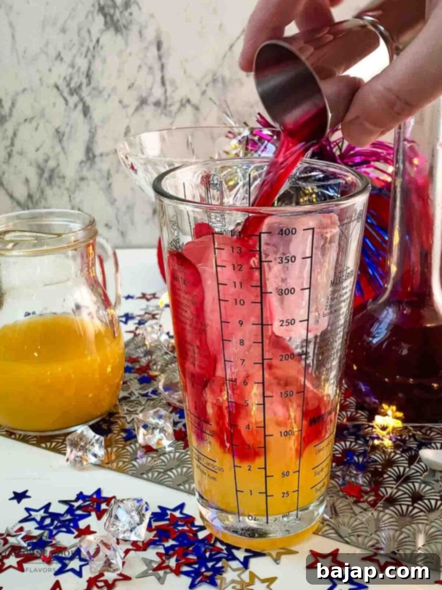 Add homemade Chambord, tequila, fresh lime juice, and orange juice to the cocktail shaker for the 4th of July Margarita.