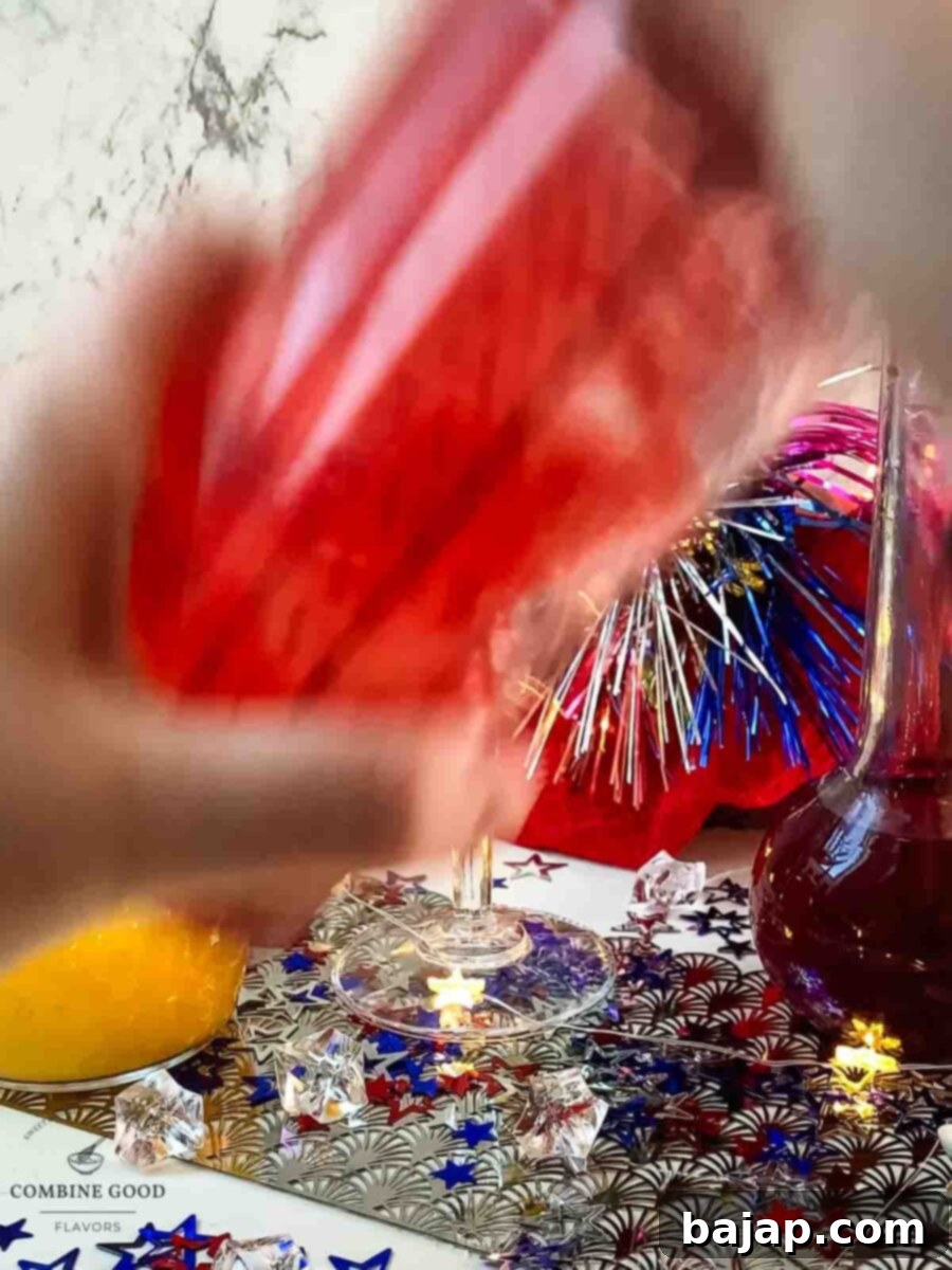 Vigorously shaking the cocktail shaker to chill and perfectly mix the ingredients for the 4th of July Margarita.