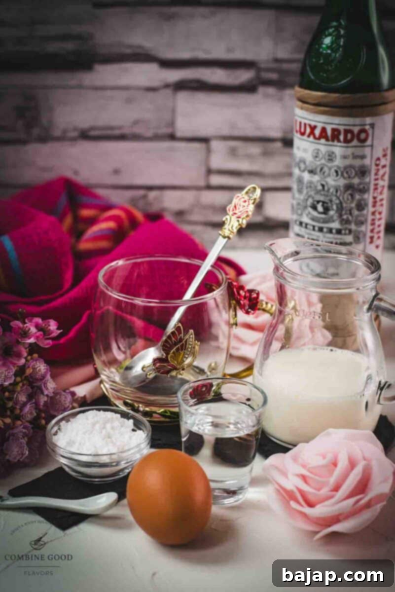 Assortment of fresh ingredients for a Maraschino liqueur cocktail, including an egg yolk, powdered sugar, a bottle of Maraschino liqueur, and hot milk in a saucepan.