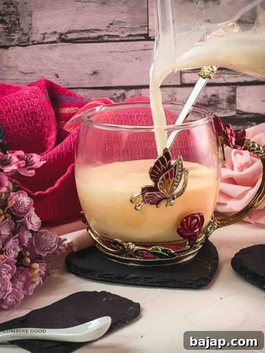 Pour the hot milk over the whipped up egg yolk sugar Maraschino mixture.