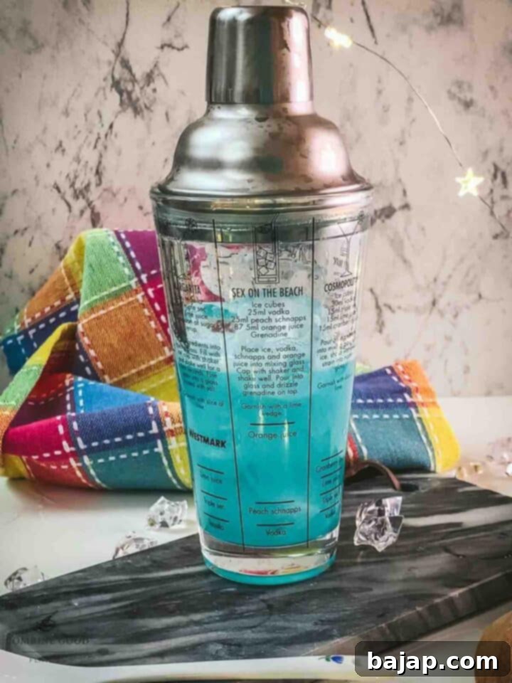Shake the Blue Lady Cocktail vigorously for 10-15 seconds to thoroughly combine and chill the ingredients.