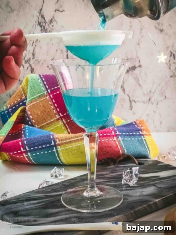 Fine strain the blue lady cocktail into a cocktail glass.
