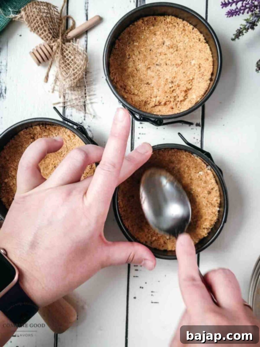 Press the lavender graham cracker crumbs into the prepared mini springform pans.
