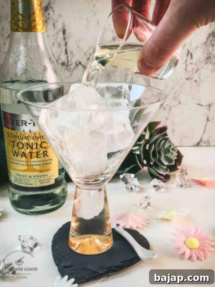 Add vermouth to the cubed ice filled glass.