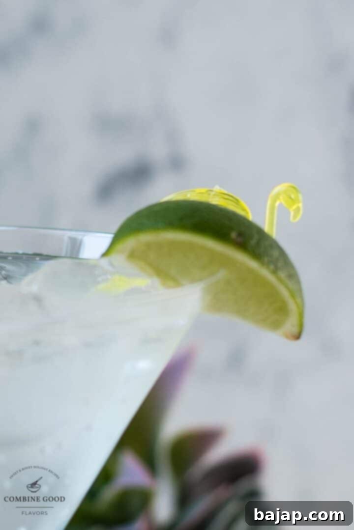 Vermouth tonic with cute garnish - lime wedge next to a yellow flamingo shaped cocktail pike.