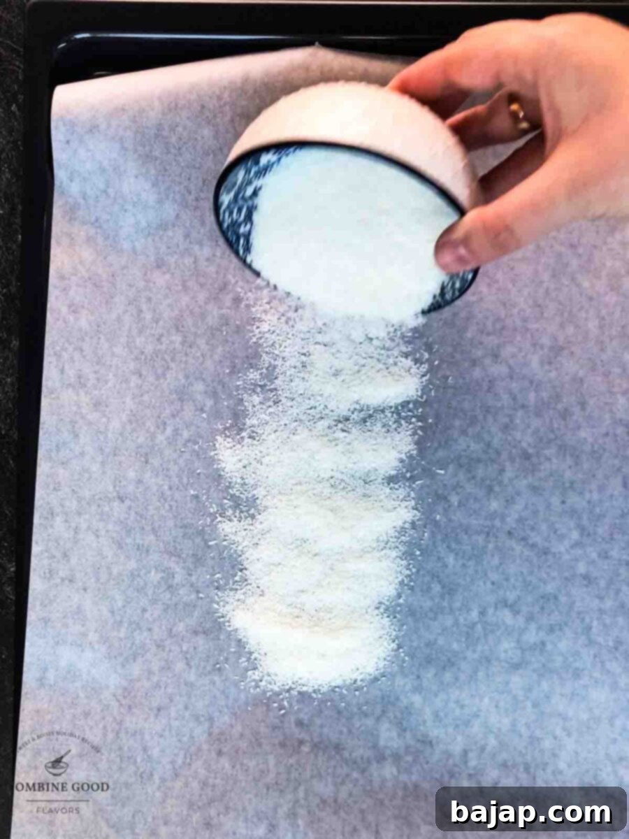 Distribute the shredded coconut evenly on a baking sheet lined with parchment paper.