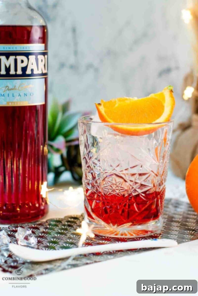 Gorgeous Negroni cocktail, served with a juicy orange wedge.