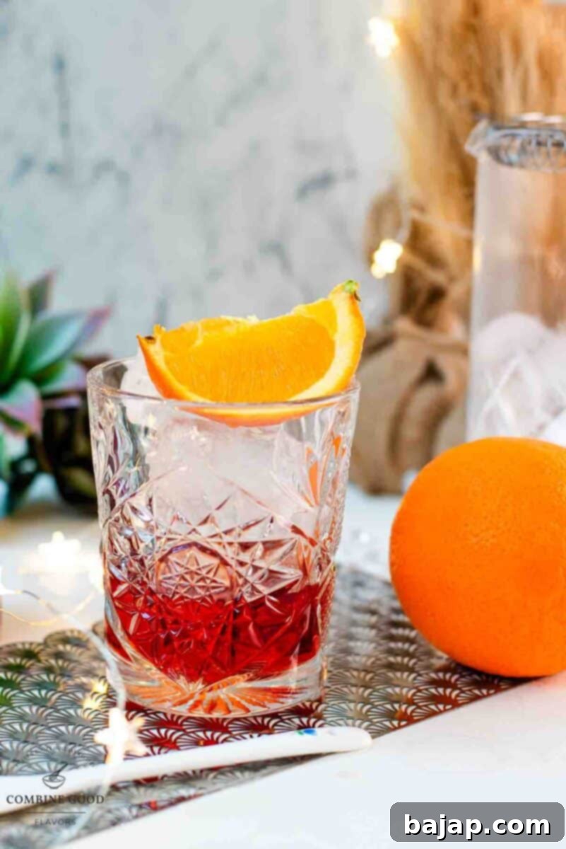 Gorgeous Negroni cocktail, served with a juicy orange wedge.