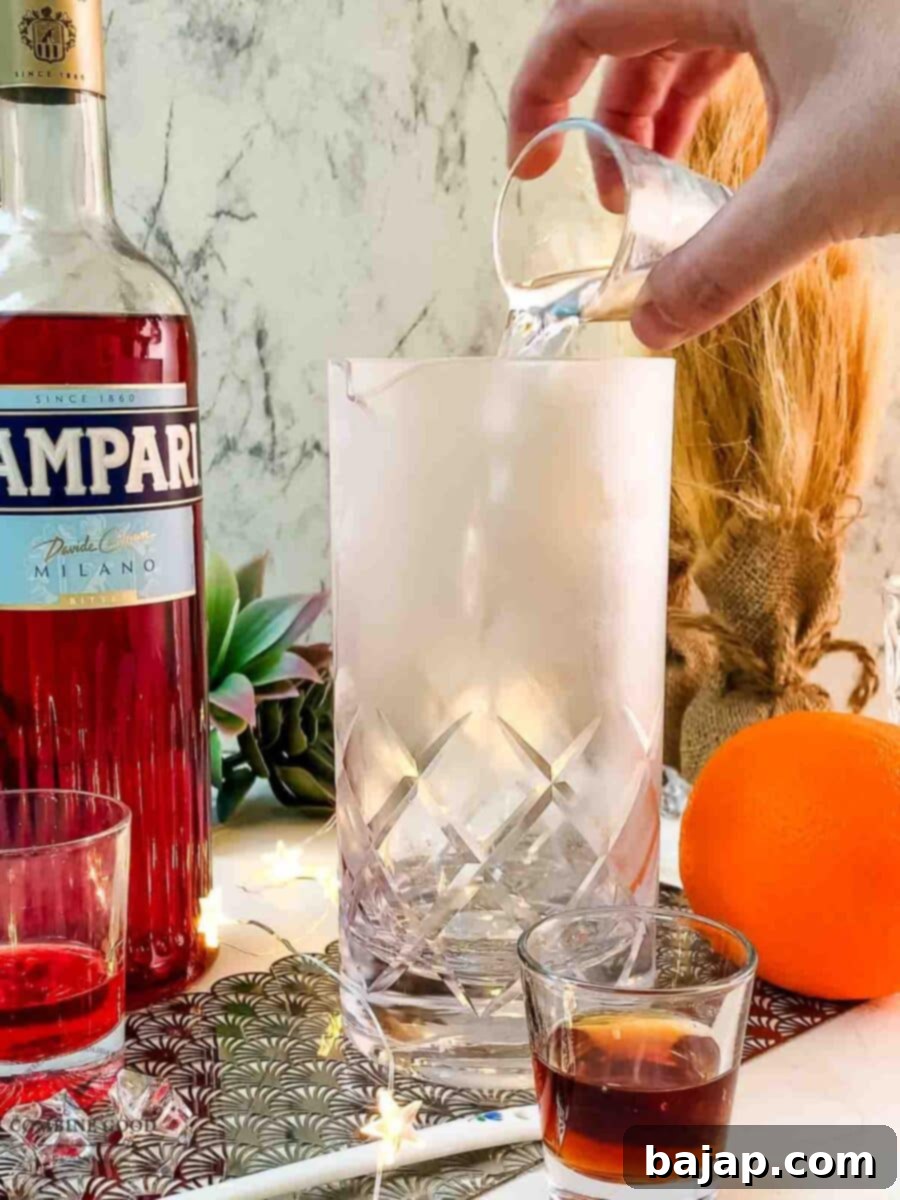Add gin to the stirring glass.