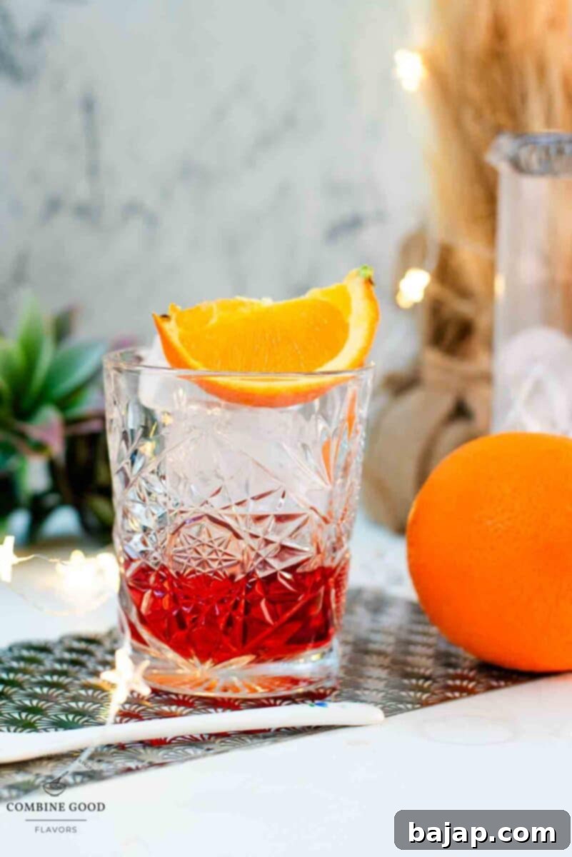 Gorgeous Negroni cocktail, served with a juicy orange wedge.