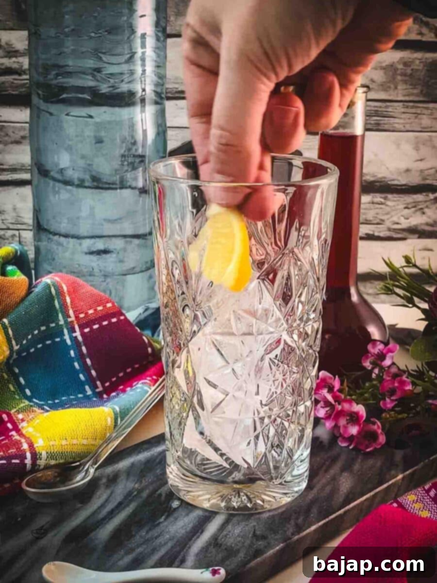 Carefully add the cubed lemon pieces to the ice-filled glass for a subtle citrus note.