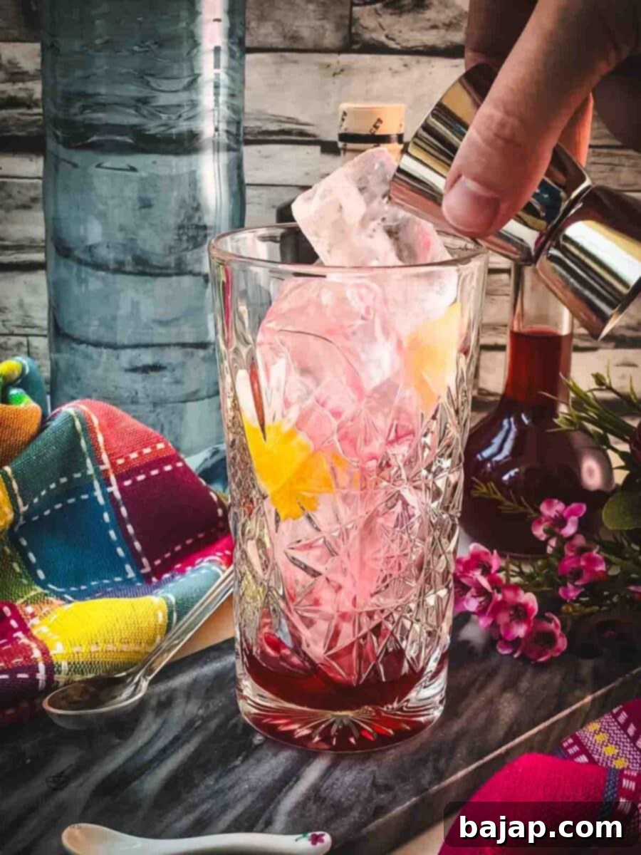 Add your favorite botanical gin to the glass, complementing the berry liqueur.