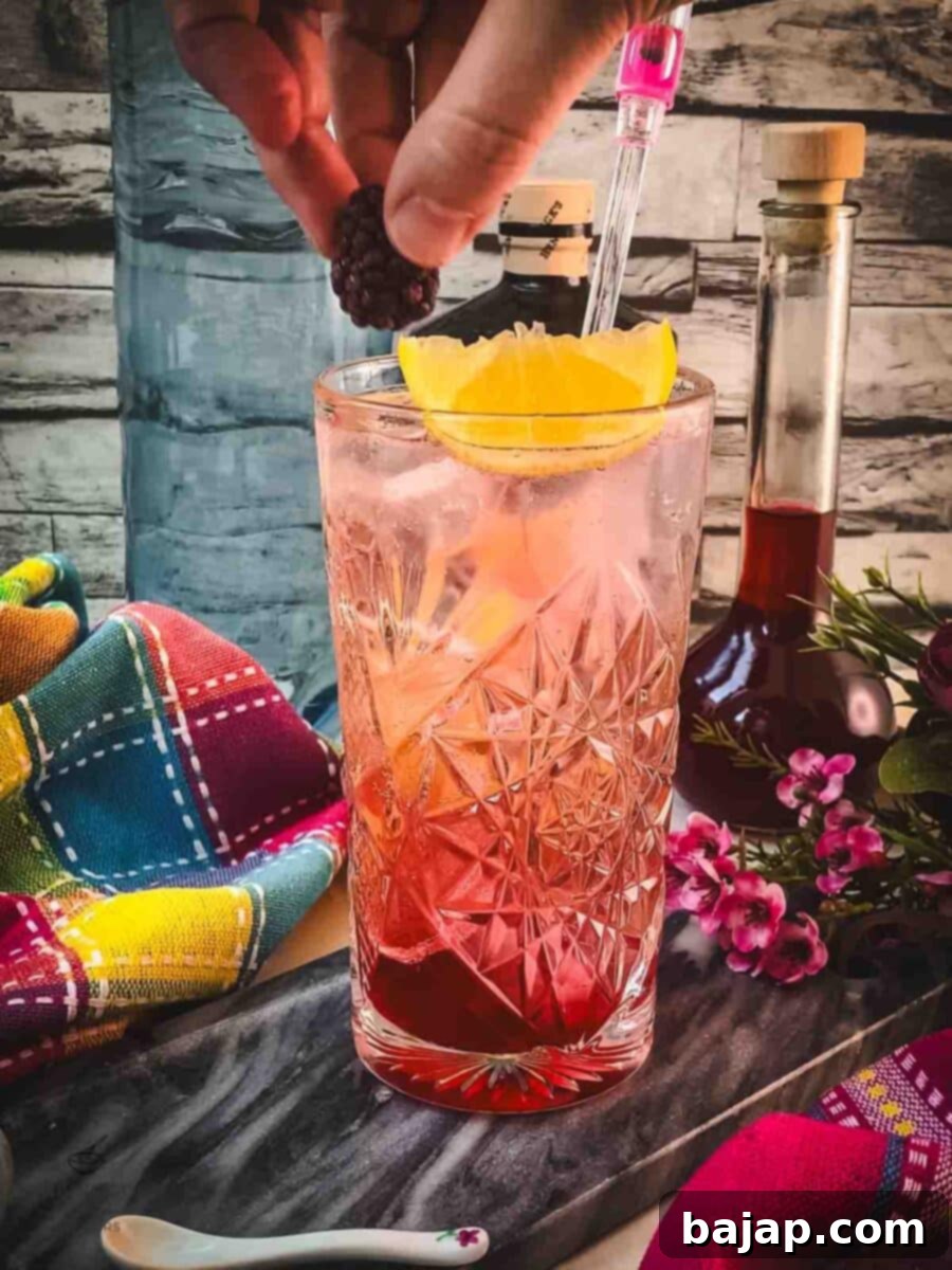 Garnish the gin fizz with a fresh lemon wedge and a juicy blackberry for a beautiful presentation.