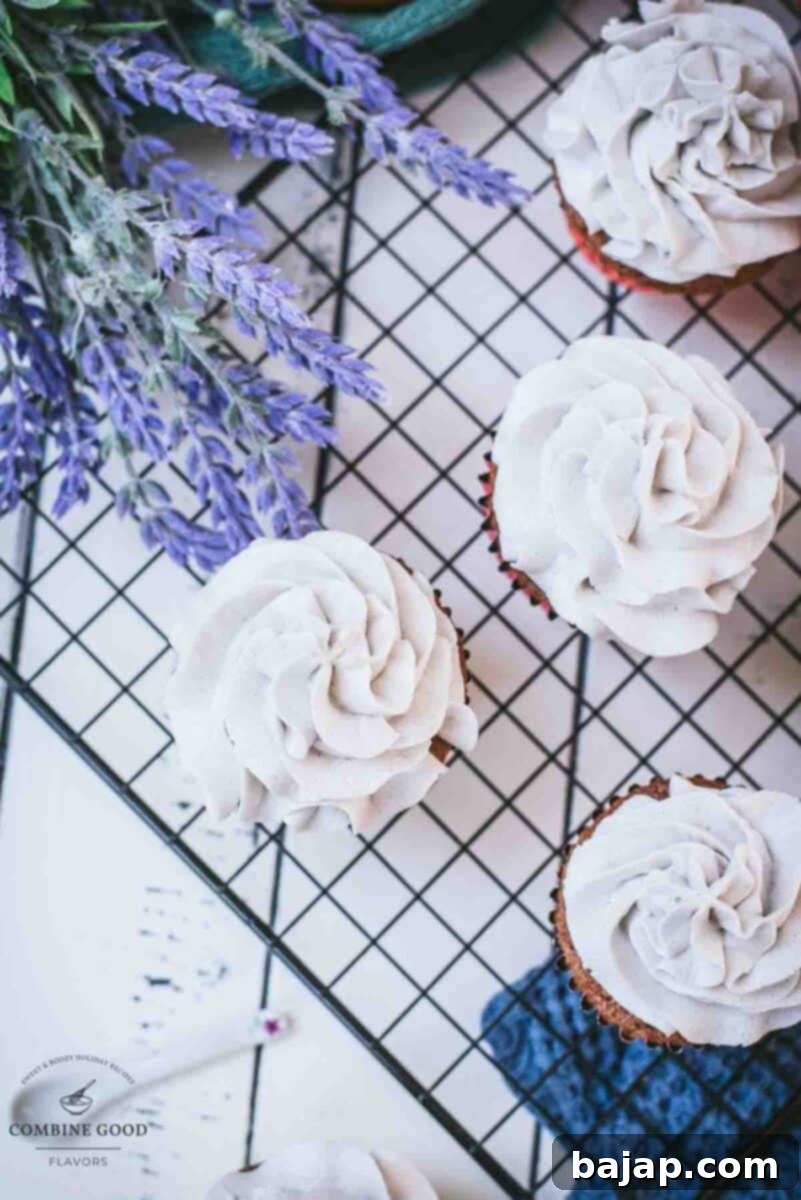 Velvet Lavender Buttercream Two Ways 8 Ready to serve orange muffins with delicate lavender buttercream frosting, arranged on a cooling rack.