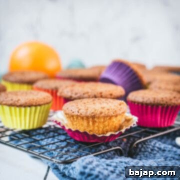 Gorgeous orange muffins placed on cooling rack.
