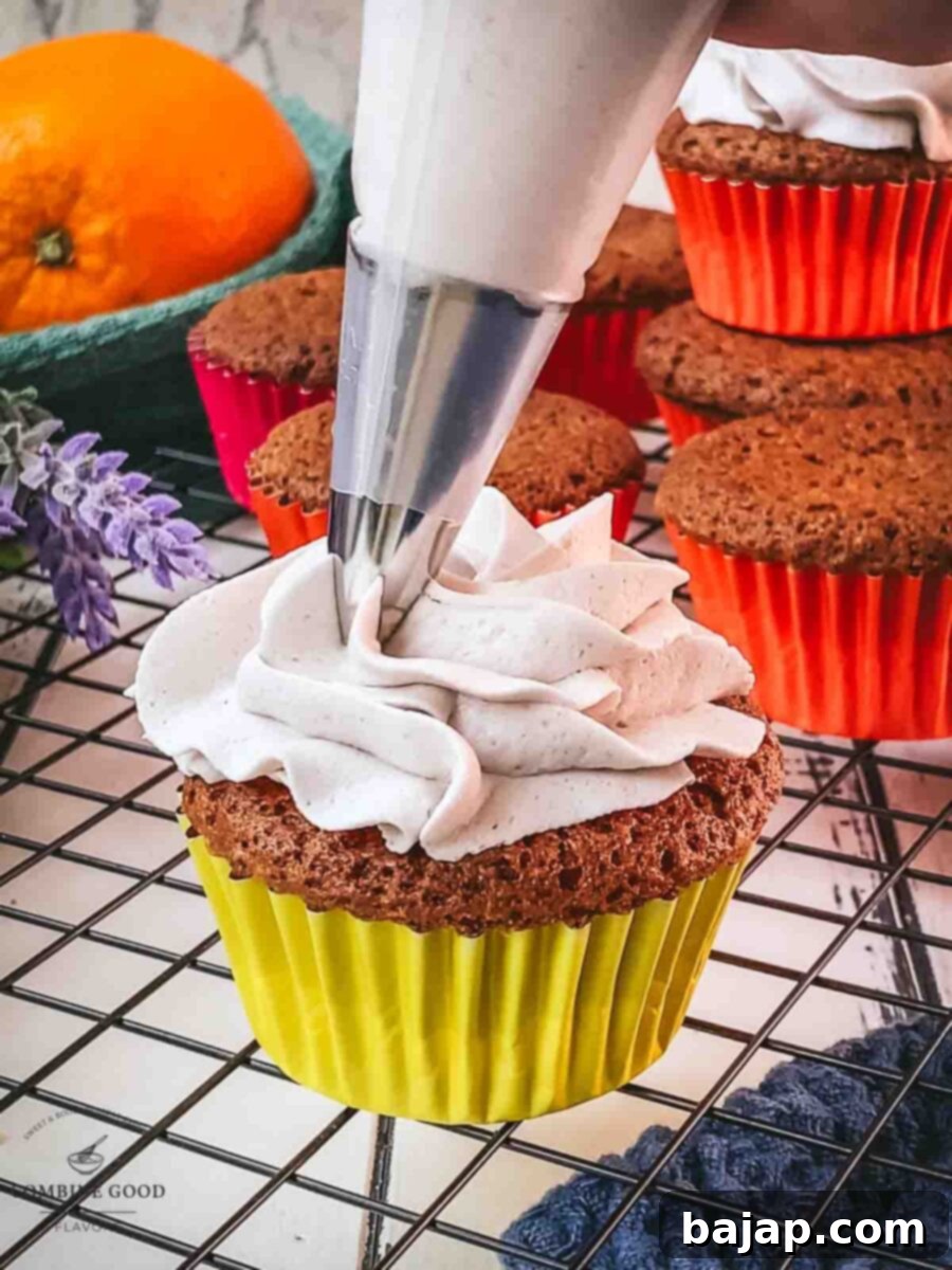Pipe the lavender buttercream on top of the orange muffins.