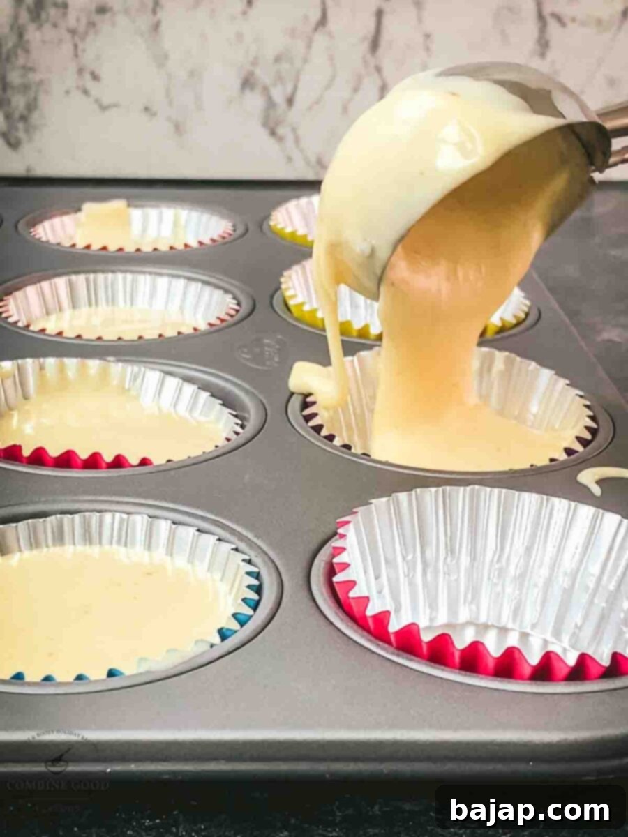 Scoop the muffin batter into the muffin tins with the help of a big ice cream scoop.
