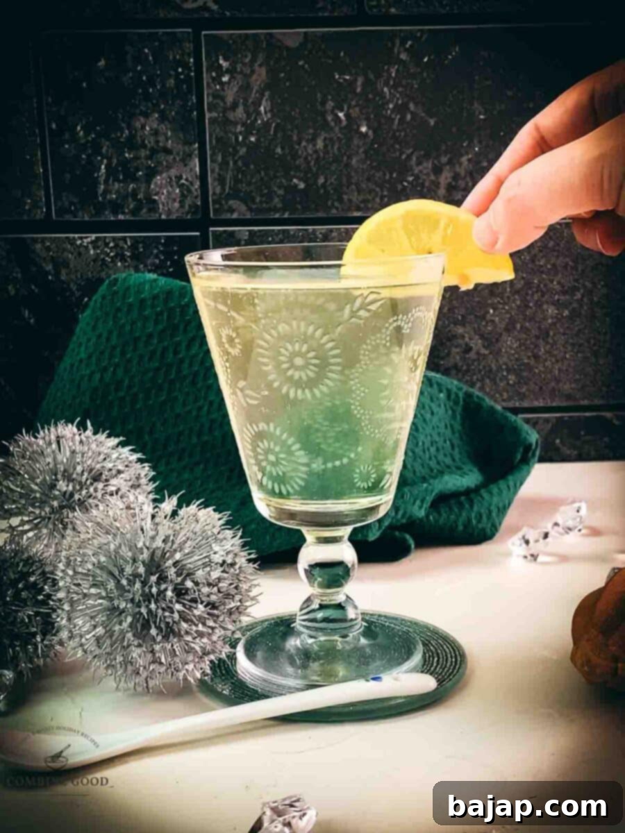 Garnishing the finished Blondie cocktail with a fresh lemon wedge.