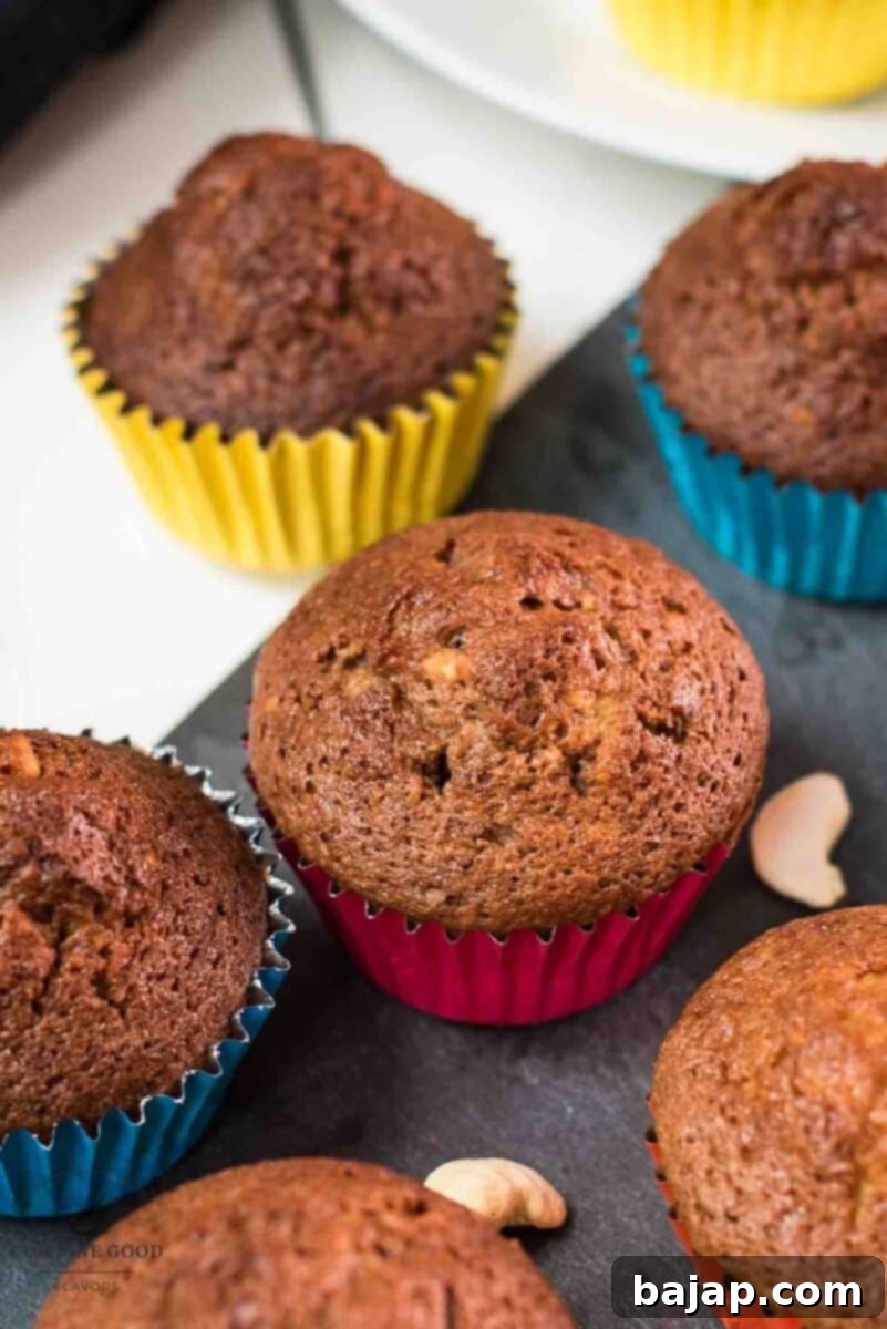 Delicious rum cashew muffins, placed on dark slate plate, showcasing both light and cocoa variations.