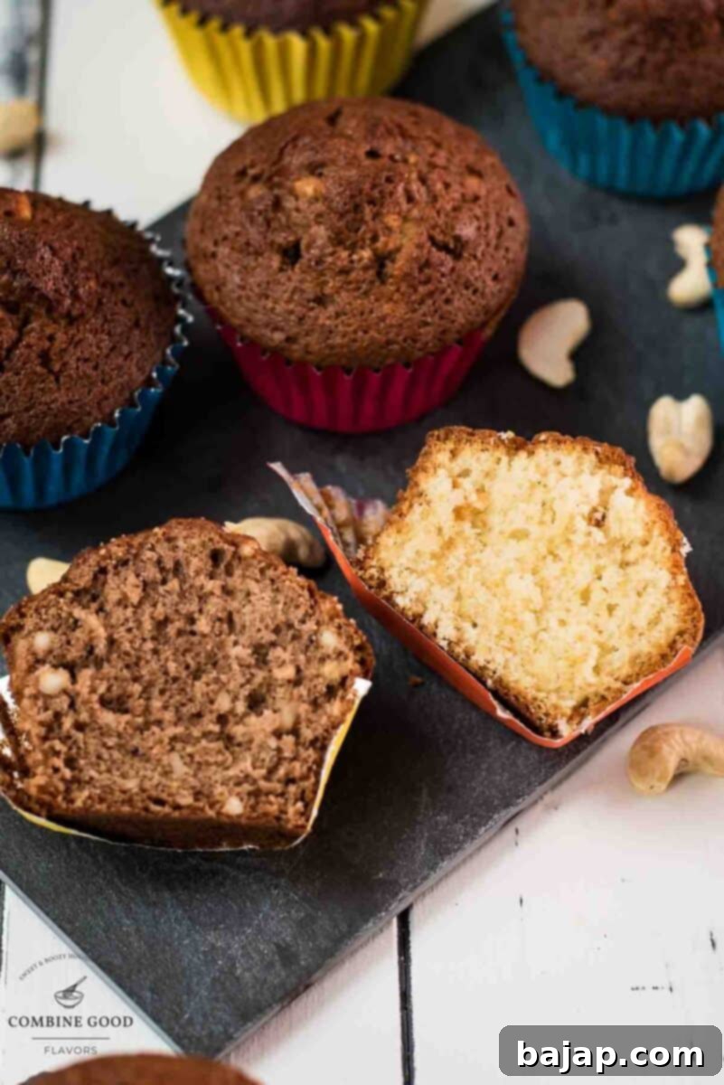 Two rum muffin halves, one with Dutch cocoa, the other without. Placed on a dark slate plate.