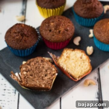 Two rum muffin halves, one with Dutch cocoa, the other without. Placed on a dark slate plate.