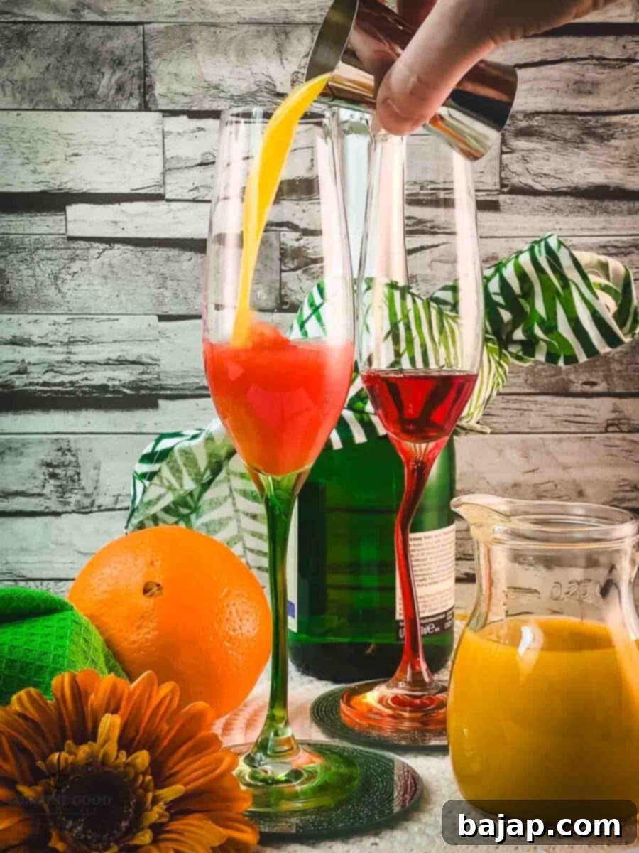 Adding fresh orange juice on top of the Campari Milano in a champagne glass, creating a beautiful color gradient.