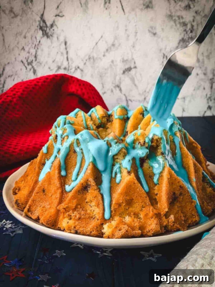 Drizzling the blue drip glaze on top of the bundt cake.