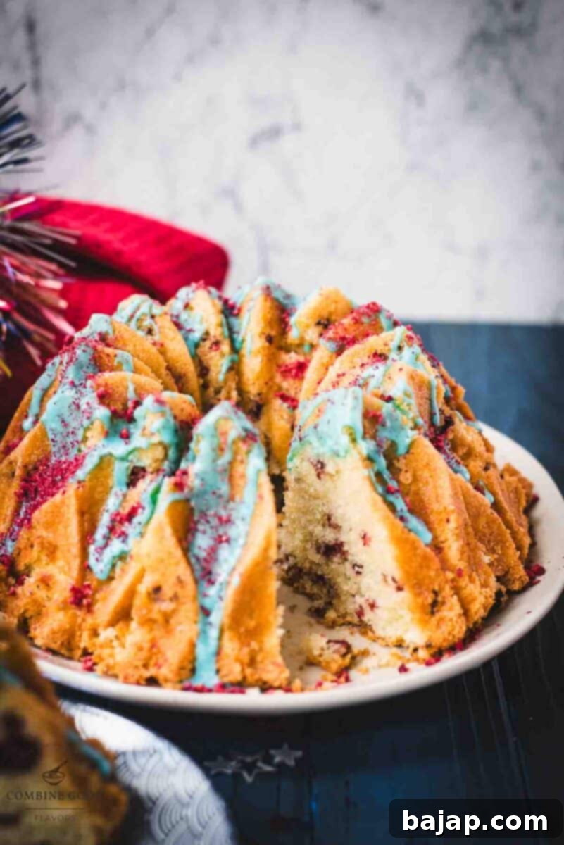 Firecracker bundt cake placed on a white plate with one slice missing, to see the gorgeous white insides.