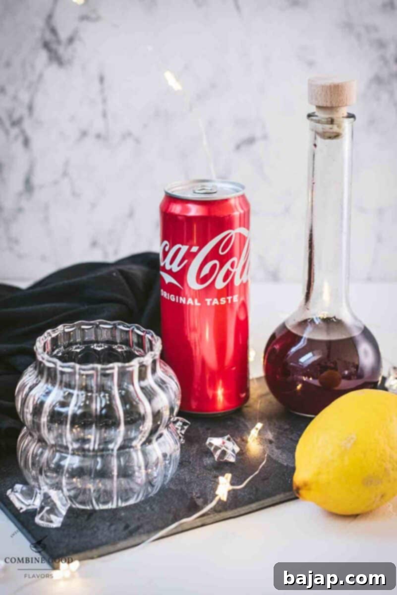 Chambord coke cocktail ingredients - coke, lemon juice, cubed ice, and homemade blackberry raspberry liqueur.