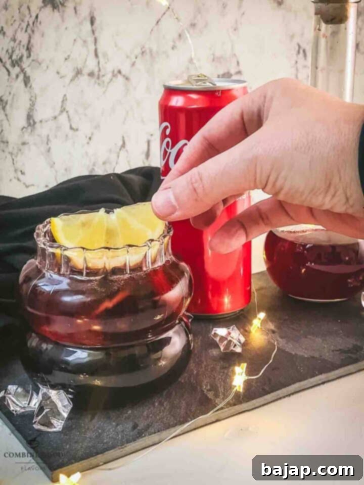 Garnish with a lemon wedge and one frozen blackberry.