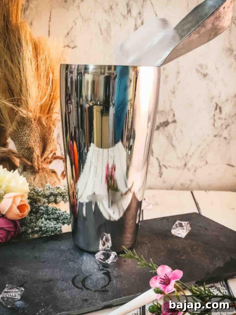 Add cubed ice to the cocktail shaker.