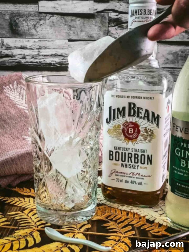 Fill a tall highball glass to the brim with large cubed ice for optimal chilling.