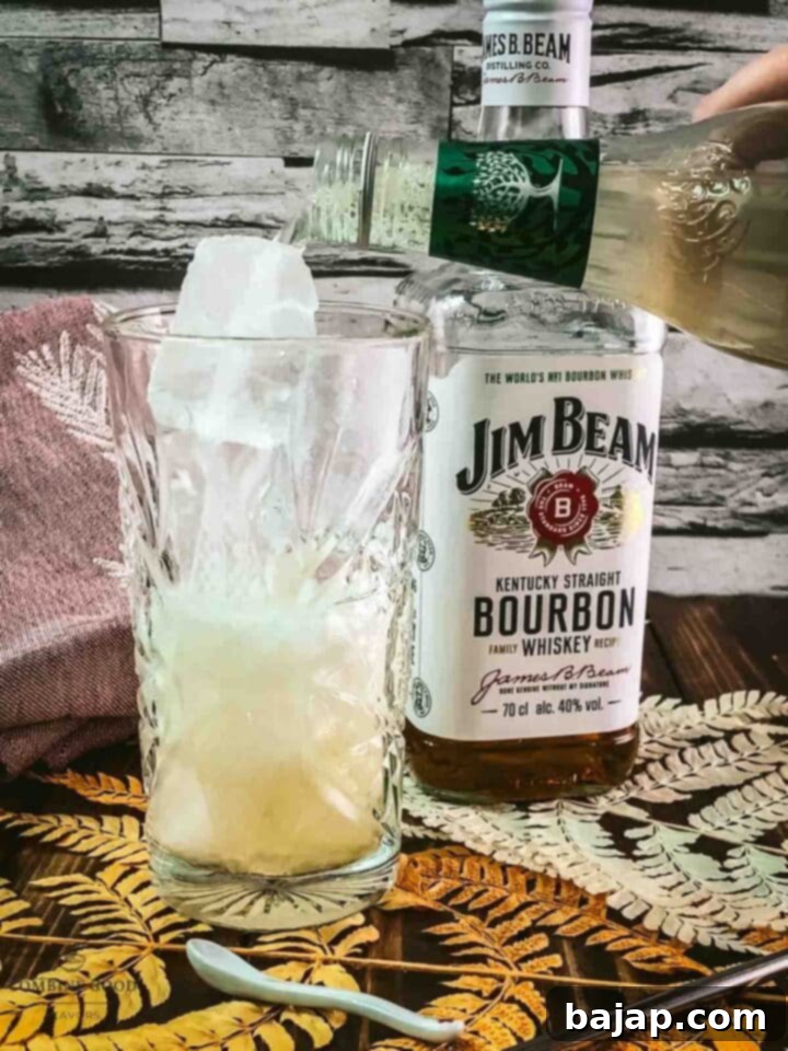 Gently top the bourbon and ice with chilled ginger beer, allowing it to fizz beautifully.