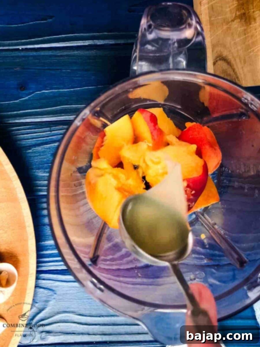 Golden Peach Purée: Perfect for Bellinis and Beyond 5 Adding fresh lemon juice to the blender with peach chunks.