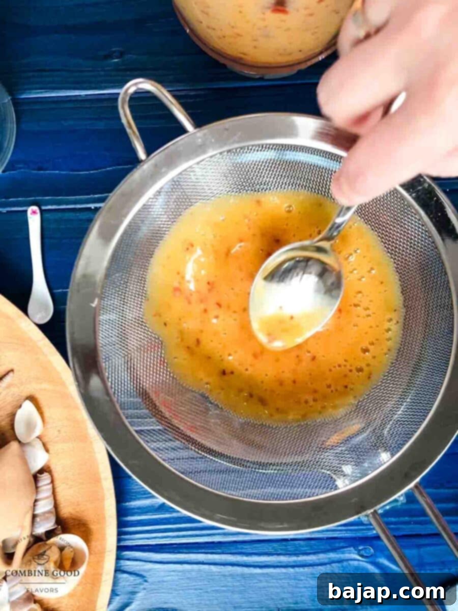 Golden Peach Purée: Perfect for Bellinis and Beyond 7 Straining the smooth peach purée through a fine sieve.