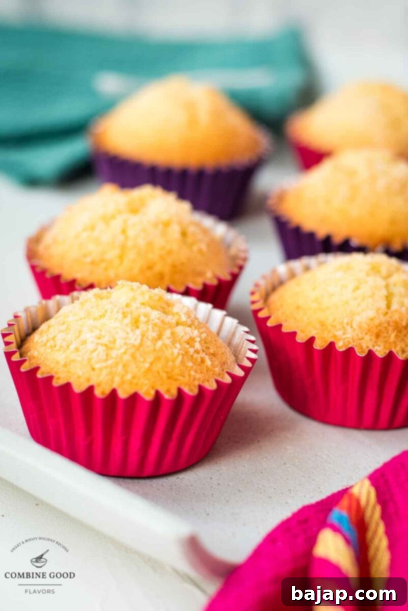 Gorgeous coconut muffins, perfectly golden and inviting, placed on a pristine white plate.