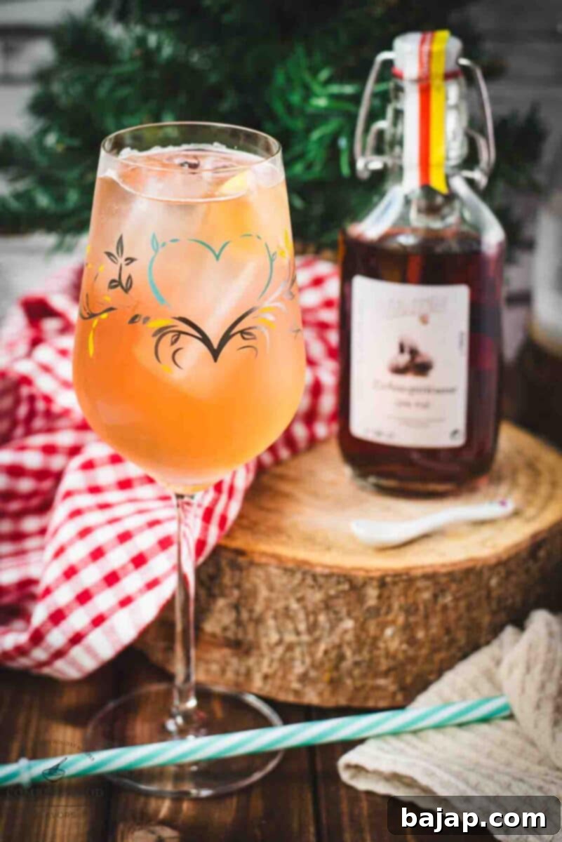 A refreshing Zirben Spritzer served elegantly in a white wine glass, sitting on a wooden surface, with a bottle of Zirben Schnapps nearby, showcasing the key ingredient.