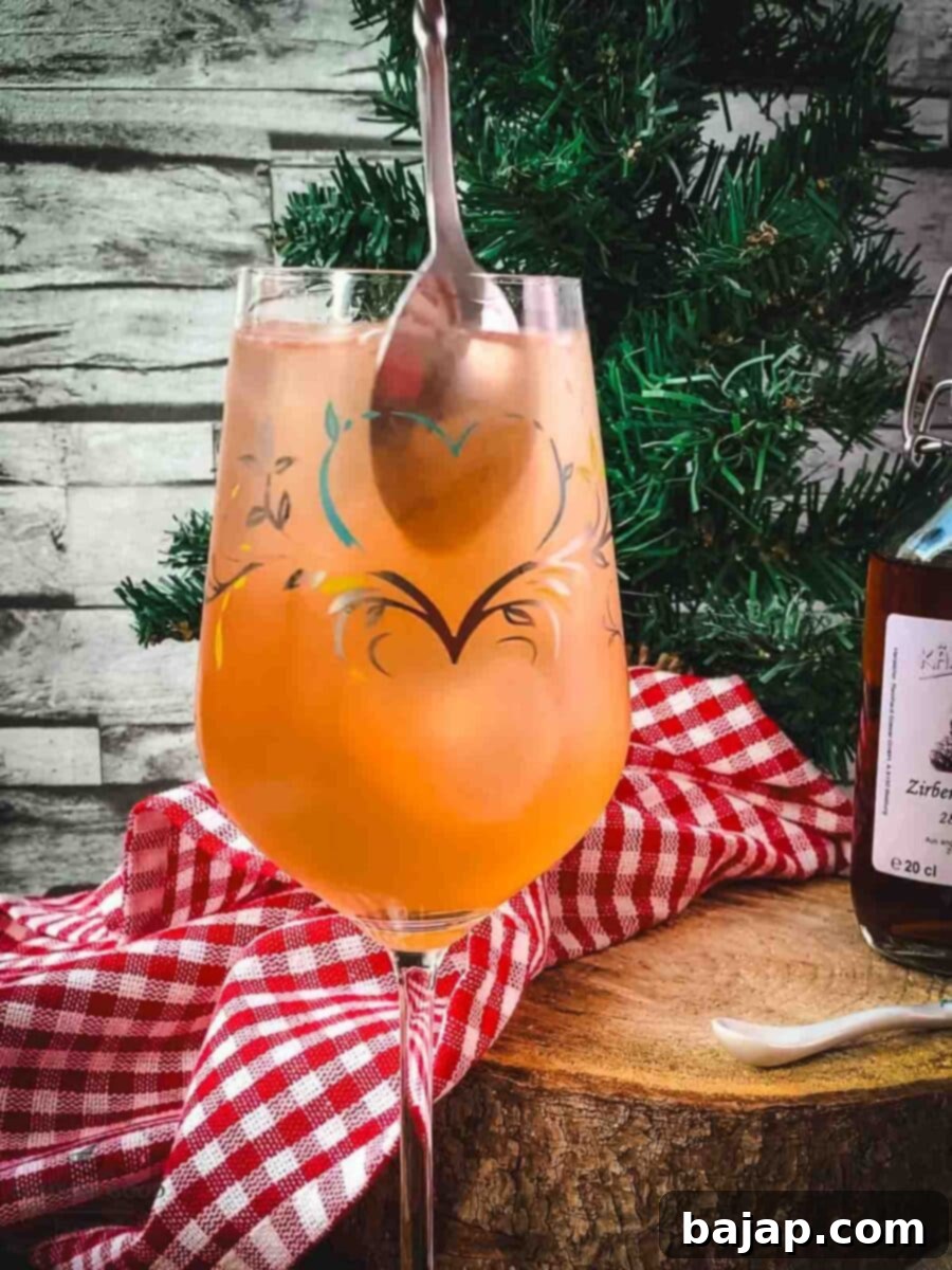 Stir the Zirben Spritzer gently to combine ingredients.