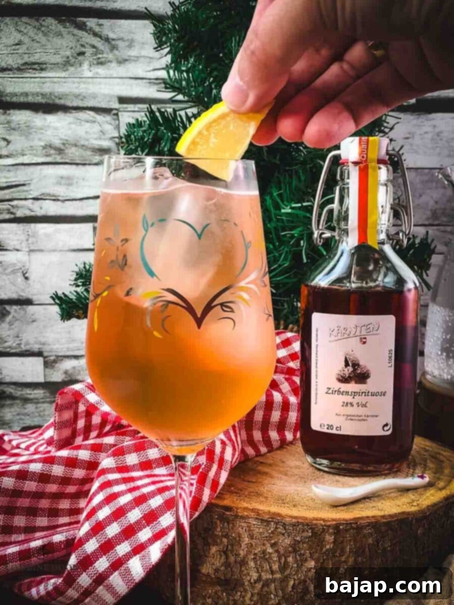 Garnish the Zirben Spritzer with a lemon wedge for an alpine touch.