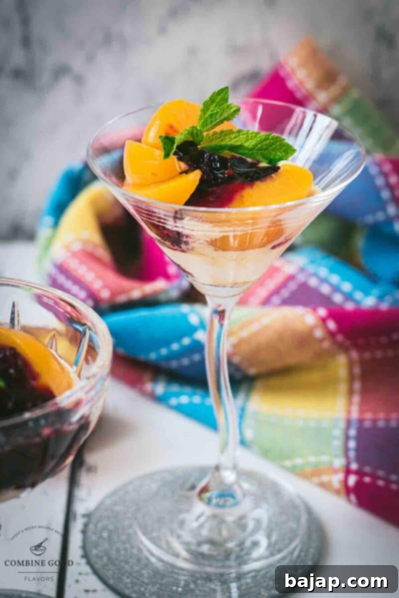 Elegant peach melba, served in cocktail glass.
