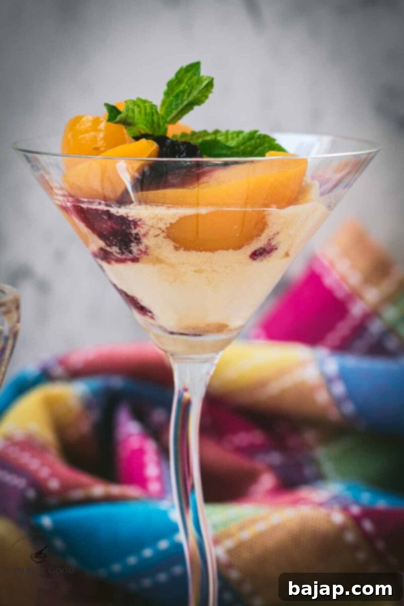 Elegant peach melba, served in cocktail glass.