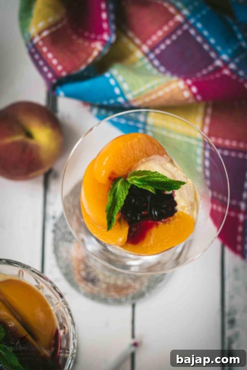 Elegant peach melba, served in cocktail glass.